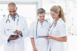 Team of smiling doctors working on their files