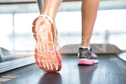 Highlighted foot of woman on treadmill
