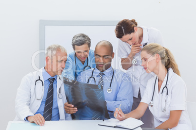 Team of doctors analyzing xray