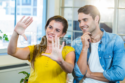 Pretty businesswoman doing frame with her hands and showing to h