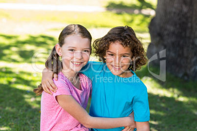 Little siblings smiling at camera