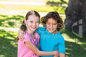 Little siblings smiling at camera