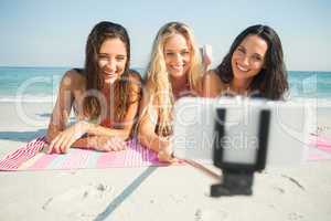 group of friends in swimsuits taking a selfie