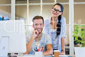 Smiling partners working together on computer