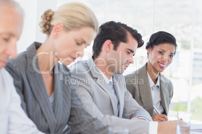 Business team taking notes during conference