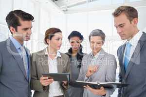 Business people with tablet and notebook