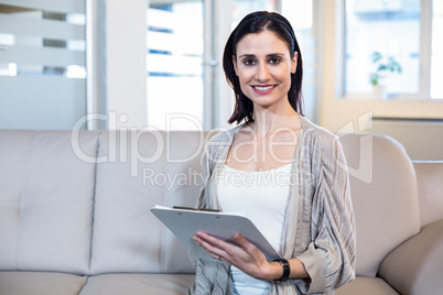 Psychologist sitting on the couch and taking notes