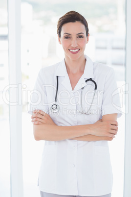 Smiling doctor looking at camera with arms crossed Smiling doctor looking at camera with arms crossed