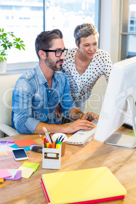 Casual businesswoman showing the screen to her partner