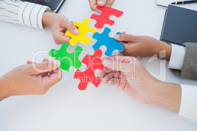 Business colleagues holding piece of puzzle