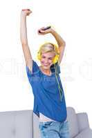 Happy blonde woman listening music with her mobile phone