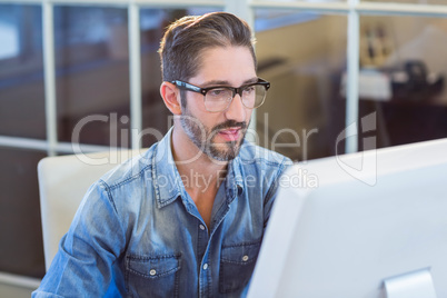 Casual businessman looking at computer screen