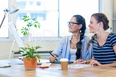 Smiling partners working together on computer and digitizer