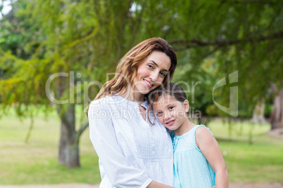 mother and daughter smiling at the camera