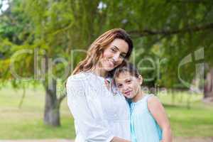 mother and daughter smiling at the camera