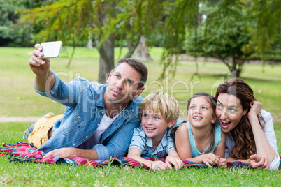 Happy family in the park taking selfie Happy family in the park taking selfie