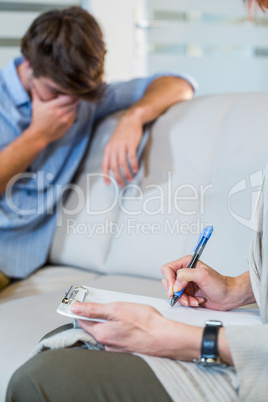 Psychologist talking with depressed man