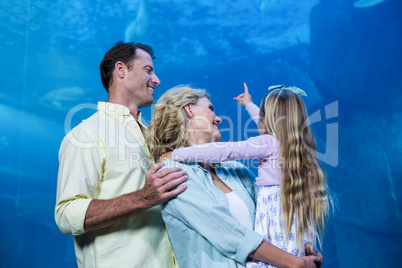 Happy family looking at the fish tank