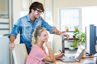 Smiling team working with digitizer and laptop Smiling team working with digitizer and laptop