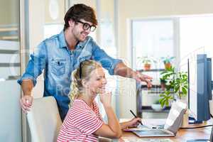 Smiling team working with digitizer and laptop