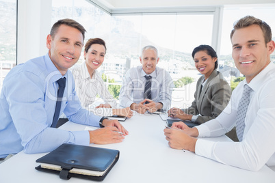 Business team sitting together around the table