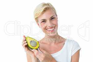 Attractive woman holding fresh avocado