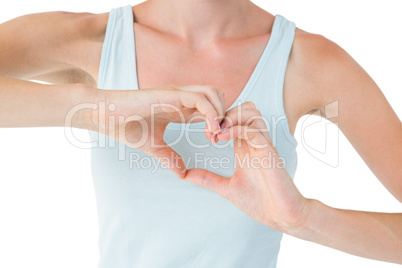 Fit woman doing heart shape with her hands