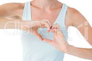Fit woman doing heart shape with her hands