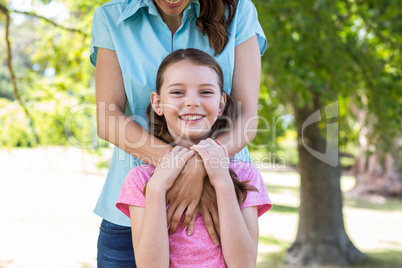 Happy mother and daughter smiling at the camera