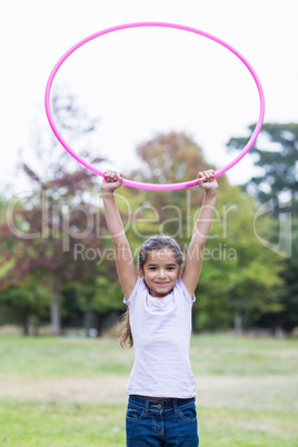 happy girl playing with hula hoops