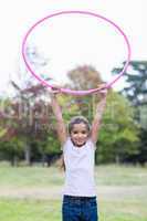 happy girl playing with hula hoops