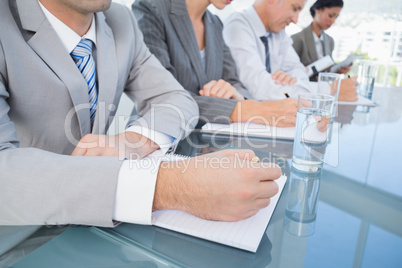 Business team taking notes during conference