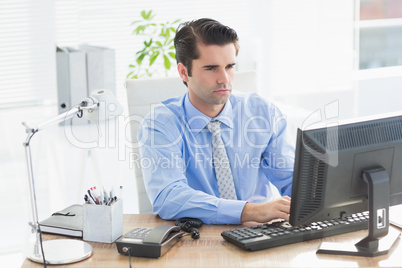 Concentrated businessman typing on the keyboard