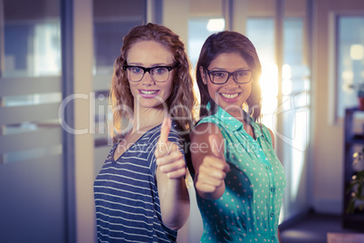 Happy designers showing thumbs up