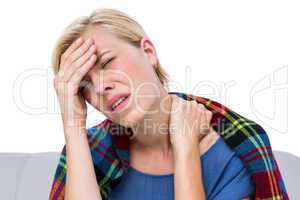 Sick blonde woman having both headache and neck pain