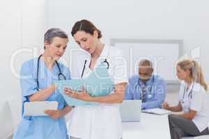 Team of doctors working on their files
