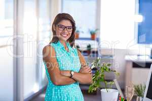 Smiling casual businesswoman posing with arms crossed
