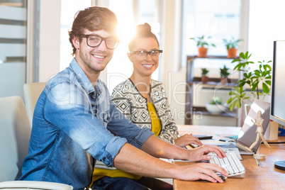 Smiling casual business team working together