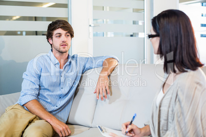Psychologist talking with depressed man