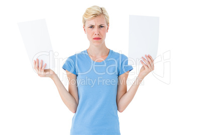 Serious blonde woman presenting paper with her hands