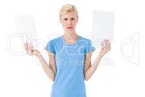 Serious blonde woman presenting paper with her hands
