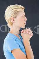 Pretty blond woman praying