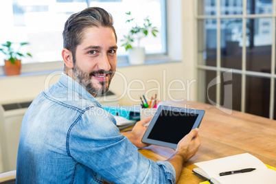 Casual businessman working at his desk with tablet