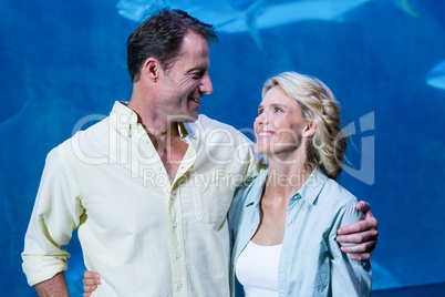 Happy couple beside the fish tank