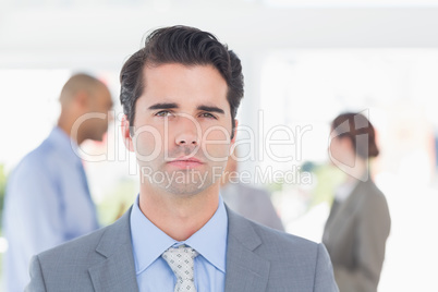 Serious businessman looking at camera