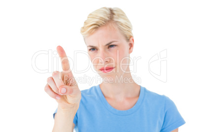 Serious blonde woman pointing with her finger Serious blonde woman pointing with her finger