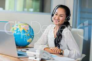 Pretty travel agent smiling at camera