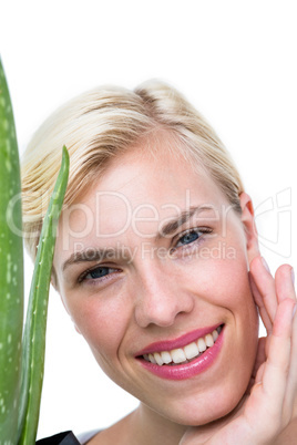 Attractive woman holding aloe vera plant