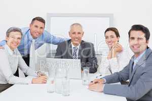 Business team working happily together on laptop