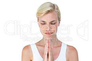 Attractive blonde woman praying